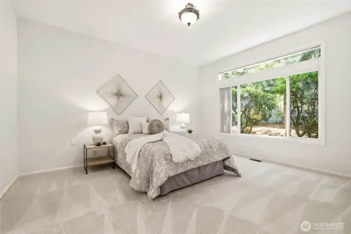 Spacious primary suite with peaceful feel. Large windows bring in natural light.