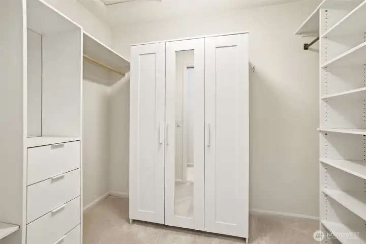 Primary bedroom custom walk-in closet with built-ins.