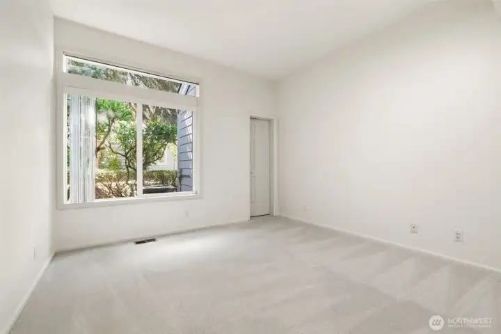 Second Guest Bedroom: New carpet and wall paint, Conveniently located across from guest bathroom, Walk-in closet, Transom window for added natural light