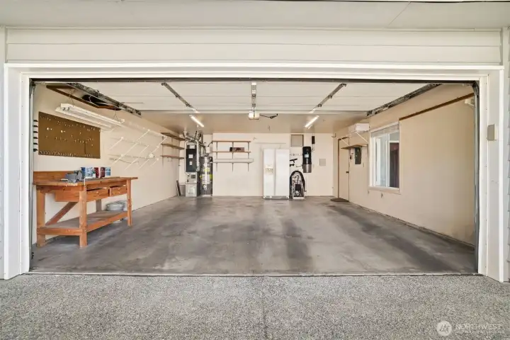 Spacious double car garage with work area.
