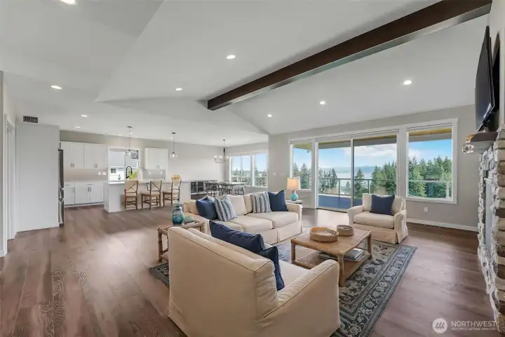 Enjoy the open concept living space with vaulted ceilings, gourmet kitchen, huge great room and dining room that all open to the expansive deck with the views as your backdrop from every corner.  Virtually staged.