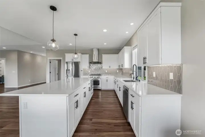 Luxury finishes throughout including LVP flooring, quartz countertops, high end appliances and top of the line Lutron smart blinds.