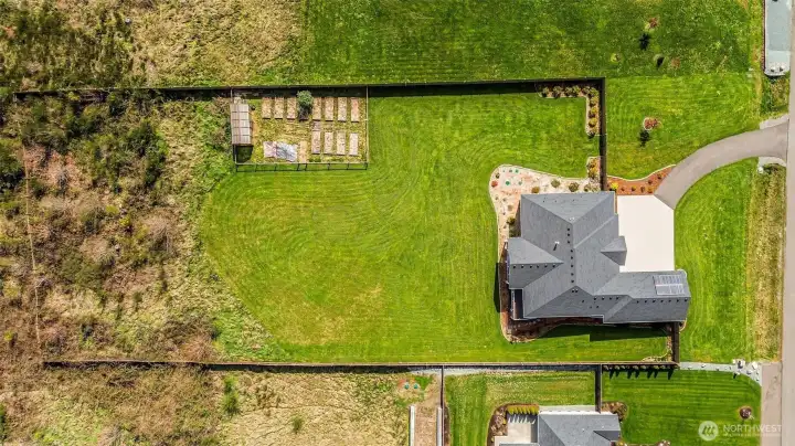 Set on 2 pristine acres, the property includes a large, fenced yard, greenhouse and dedicated garden space.