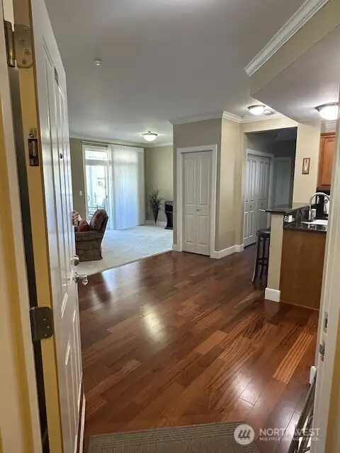 Condo #204 is a few steps from the elevator. As you walk into the condo it feels very spacious with the 9' ceilings and light from all the windows.  The flooring is stunning Brazilian Cherry engineered hardwood which is known for its durability! In other words, it isn't LVP type..