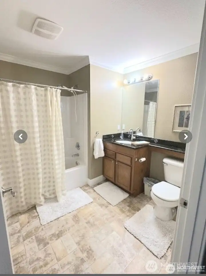 A guest bath with a tub is located near the two bedrooms.
