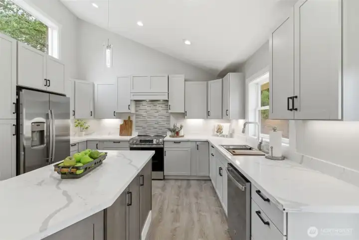 Quartz counters, designer backsplash + custom cabinetry with soft-close doors/drawers + pull-outs & recycle center. The chef in the family has lots of room to move.