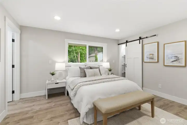 Sliding barn door opens to a convenient linen/shoe /sweater/anything- closet in the primary bedroom.  ALL closets throughout the home have interior lights