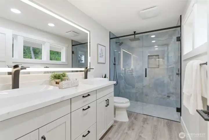 Spa-quality primary bath includes a 6' glass enclosed shower with Thermostatic rain  showerhead, hand wand & spray head, heated Aevar illuminated vanity mirror & Bluetooth-enabled ventilation fan. Mornings will be time you look forward to!