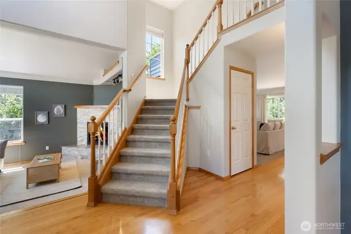 Vaulted entryway with warm oak floors