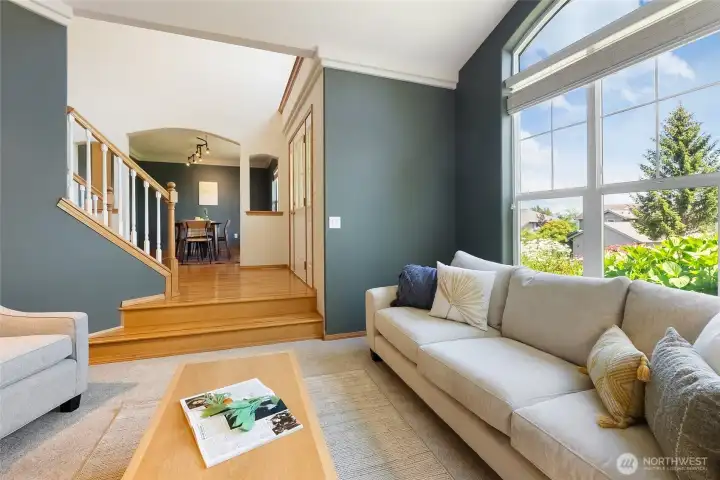 The sunken living room with fresh carpet adds to the cozy feel