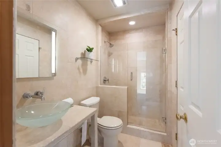 Second full bathroom with custom travertine tile throughout