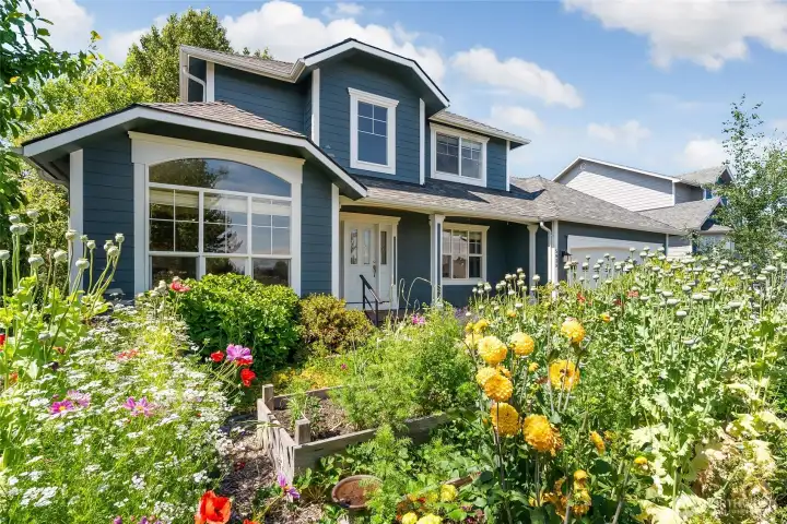 Incredible mature landscaping with berries, flowers, fruit trees and more