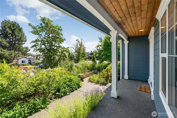 Perfect covered front porch to enjoy the beautiful garden and southern views