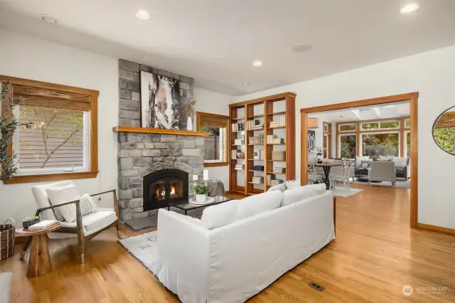 Walk inside to this wonderful living room with tall ceilings, a wall of built-in book shelves for your books and treasures and a cozy centerpiece stone fireplace.