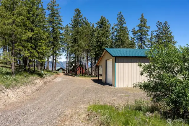 Garage shop is completely finished. Woodstove. Concrete slab on grade. Covered area attached to Building. Projects will almost complete themselves in this shop! Solid build.