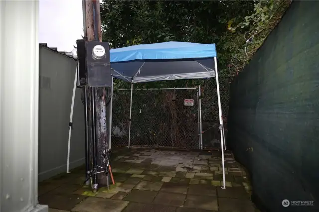 Privacy Space tucked between shed & privacy fence behind the home.