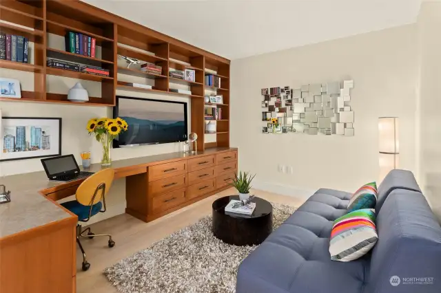 Custom cabinets in the media room with sliding door for privacy.  It doubles as an office and potentially a third bedroom.