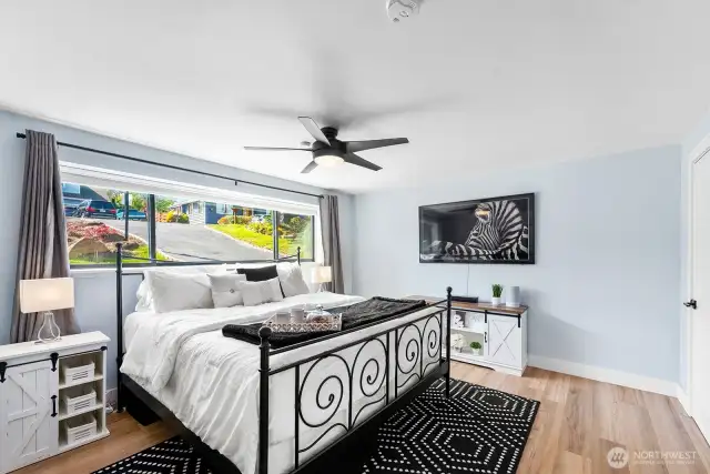 Bright, primary bedroom features on suite bath, walk in closet and, private patio!