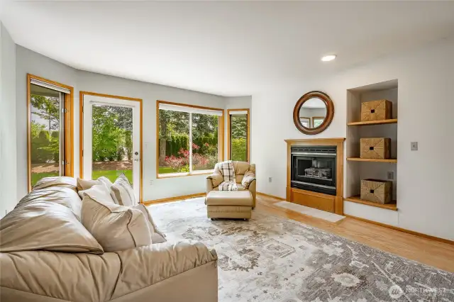 Open floor plan with gas fireplace in living room and door to back patio