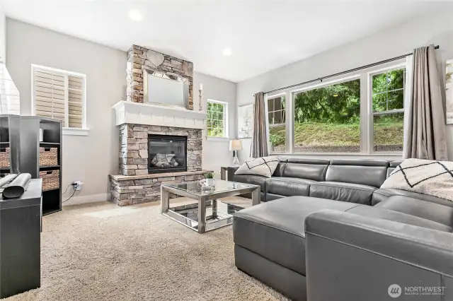 Main living room, note large window and gas fireplace