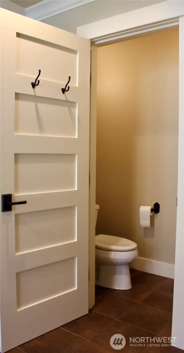 Water closet in main bedroom has a door