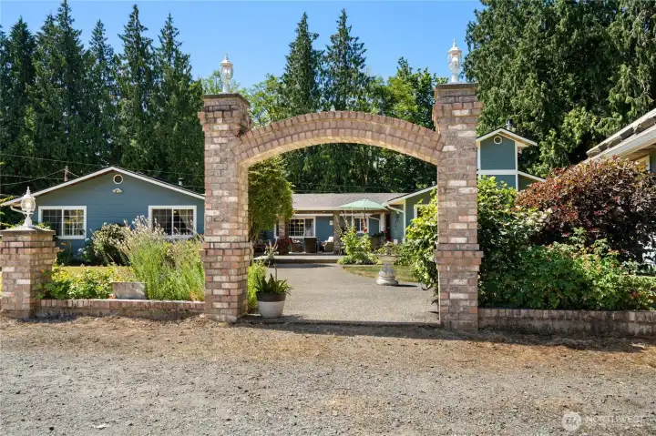 Grand stone arch invites you into this exceptional rural retreat.