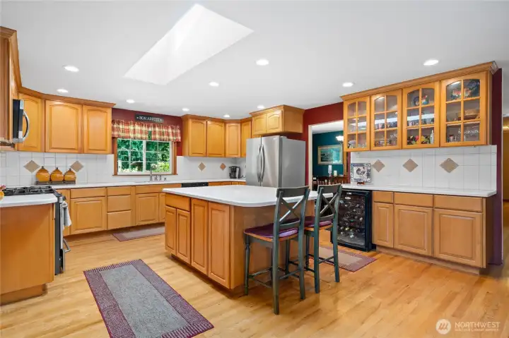 Bright and functional kitchen with skylight, breakfast bar, and tons of storage.