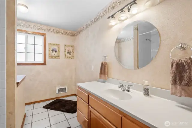 Spacious bathroom with large tub and separate shower.