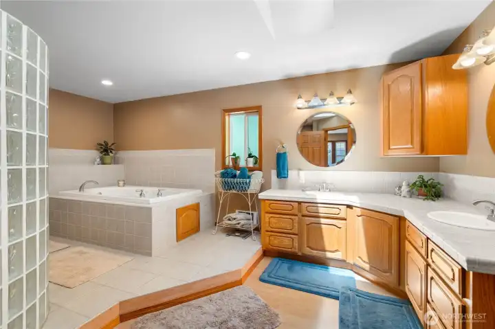 Well-appointed bathroom with large vanity, full tub, and shower