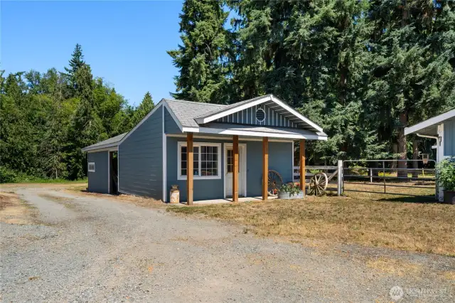 Cute and functional outbuilding with covered porch, sub panel installed—just needs power. Ideal as a tack room or potential future MIL conversion.