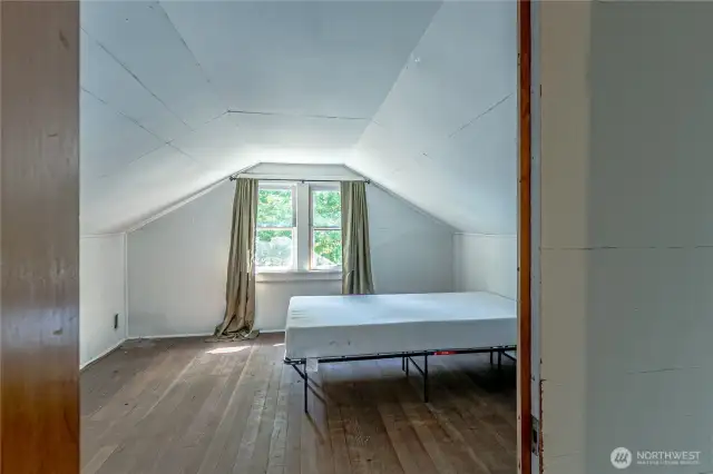 Upstairs unfinished area with pull down ladder