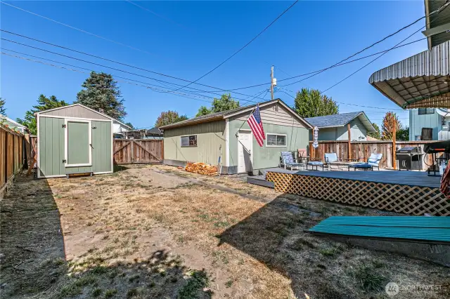Large yard with deck, garage & shed
