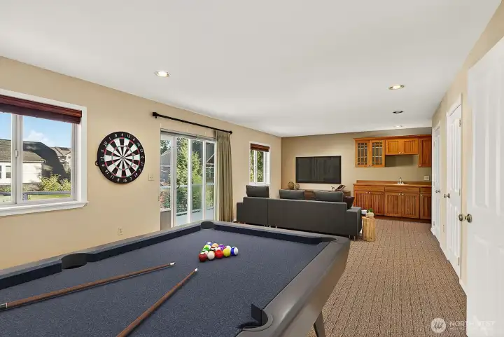 Upstairs rec room with wet bar, spot to add a gas fireplace and an upper deck.