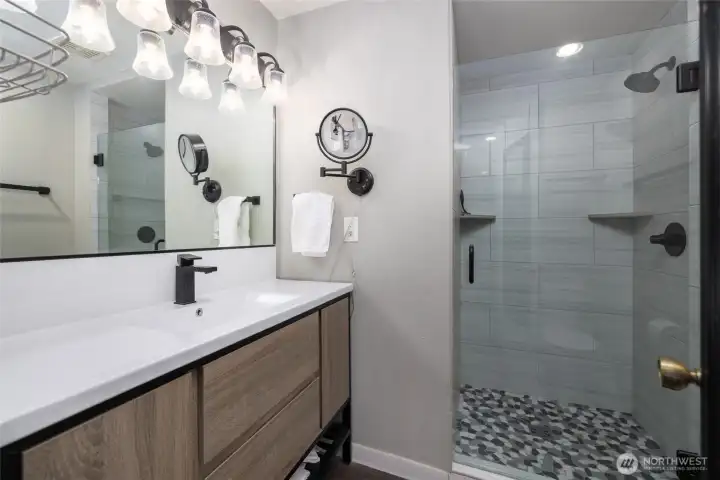 Primary ensuite bathroom has been fully remodeled and updated, including tiled step-in shower, new vanity, new fixtures and floor.