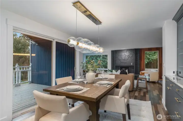 Dining area with view of wrap around deck and living room.