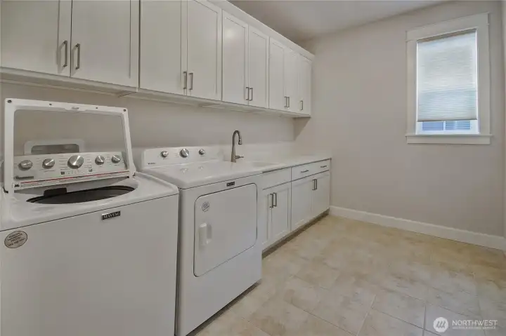 Laundry room with plenty of cabinet space plus a deep sink.