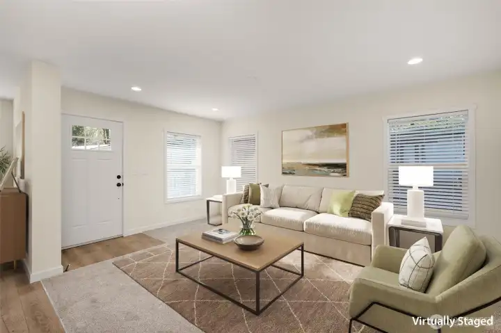 Virtually staged living space flows seamlessly into the kitchen and dining area