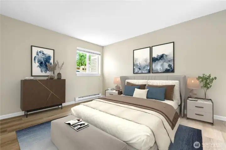 Spacious primary bedroom with new luxury vinyl flooring.
