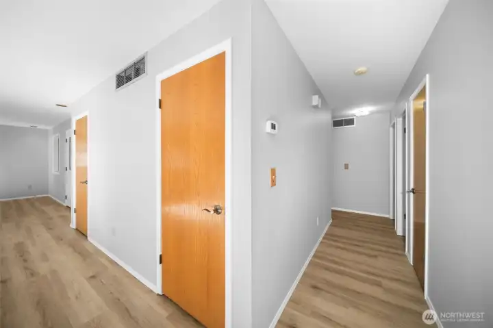 Hall leads to three bedrooms & bathroom. Door leads to lower floor.