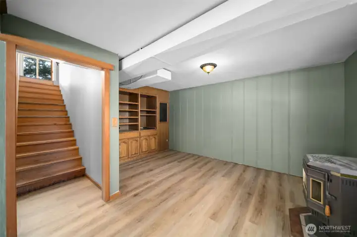 Lower level space with pellet burning stove.