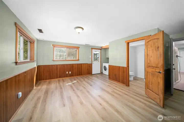 Lower level area with half bathroom & laundry area.