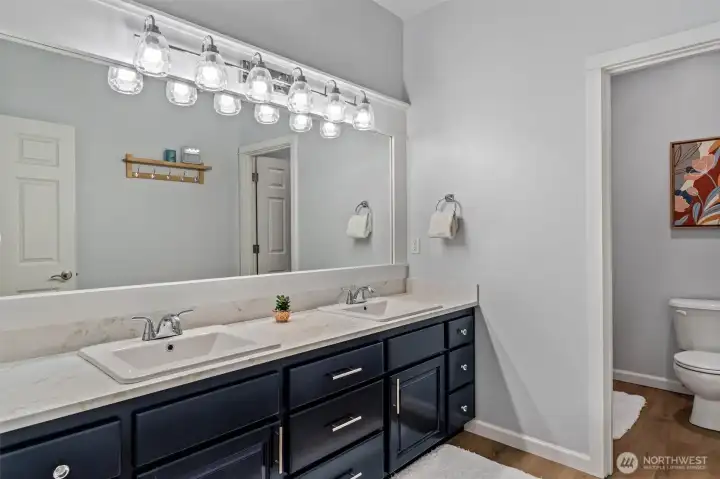 Upper hall bath with separate shower room.