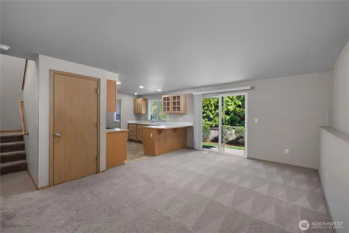 Rec room right off the kitchen leads to the backyard via the slider.