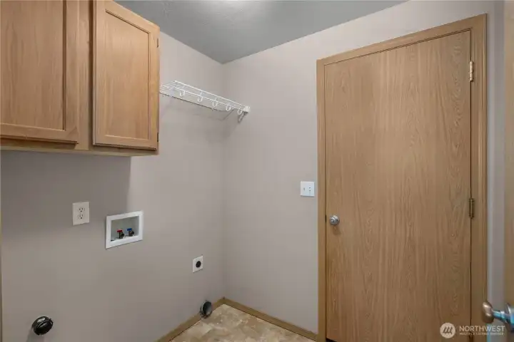 Laundry room located on the main floor with pass through door to garage