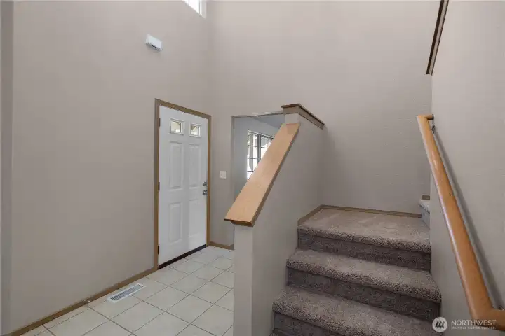 Another view of the entry and stairway leading to second floor