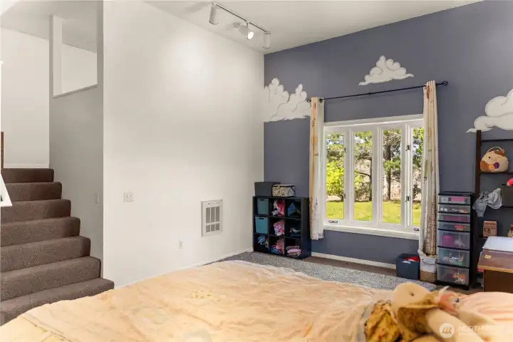 Main floor bedroom view 2 with stairs to loft area