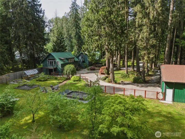 Overview of garden from creek area, shop, carriage house