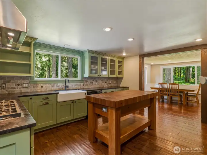 custom island featuring John boos 4 inch thick solid cherry checkerboard butcher block and cast iron  porcelain farmhouse sink