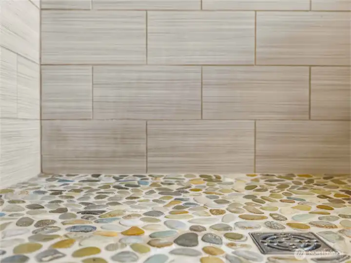 Upstairs shower featuring stone floor