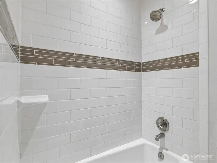 downstairs full bathroom of carriage house  with porcelain subway tile
